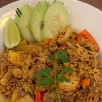 Pineapple Fried Rice · Stir-fried rice with choice of meat, cashew nut, egg, carrot, onions, tomatoes, peas, raisin...