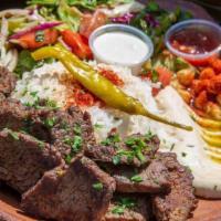 Lamb Gyro Plate · Marinated chicken served with salad and rice, tzatziki, hummus and choice of sauce.