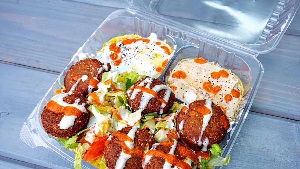 Falafel Over Rice Plate · Chick peas mixed with herbs, garlic, onion and spices. Served with hummus, tahini sauce, salad and pickles.Rice, tzatziki, hummus.