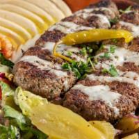 Beef Kabab Over Rice Plate · Beef, rice, mix salad, tzatziki, hummus and choice of sauce.