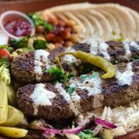 Kafta Kabab Over Rice Plate · Ground beef with chopped onion and parsley seasoned with a blend of spices, rice, mix salad,...