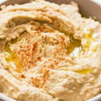 Hummus · A creamy dip of chickpeas, tahini, lemon and garlic. Topped with olive oil.