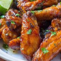 Garlic Serrano Wings · Crispy wings, tossed with garlic and serrano peppers