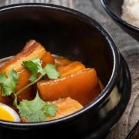 Coconut Pork Belly · Braised pork belly, soft boiled egg, served with pickled vegetables, and jasmine rice