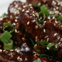 Sesame Beef · Flour dusted flank steak, sesame seeds, garlic, ginger, and sweet and spicy house sauce.