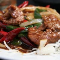 Mongolian Beef · Yellow and green onion, chili pods, and house sauce over crispy rice noodles.