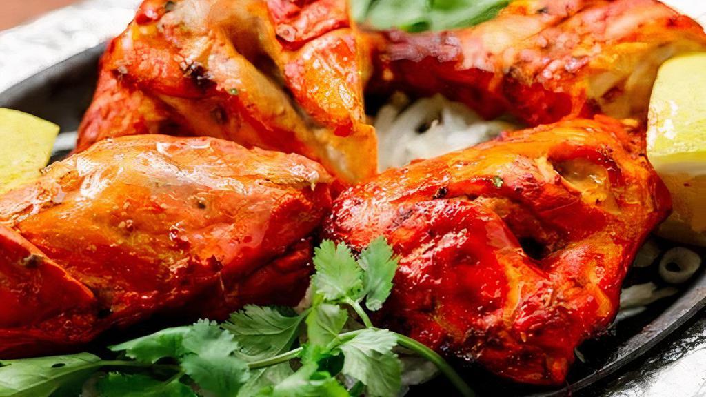 Tandoori Chicken · Marinated pieces of chicken cooked on the bone.