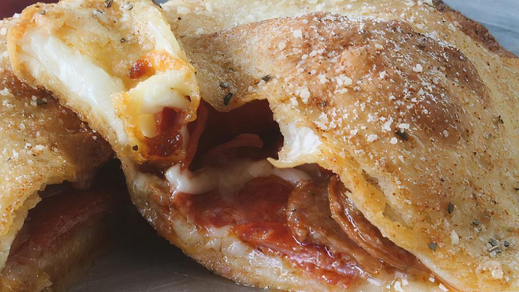 Meat Lovers Calzone · pepperoni, spicy sausage, Canadian bacon, & mozzarella