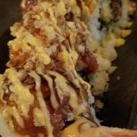Show Roll · Shrimp tempura, eel, and avocado, topped with spicy tuna and  tempura bits, drizzled with sp...