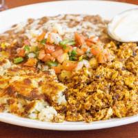 Chorizo & Eggs · 3 eggs* scrambled with spicy house made chorizo.  Served with refried beans, home fries, pic...