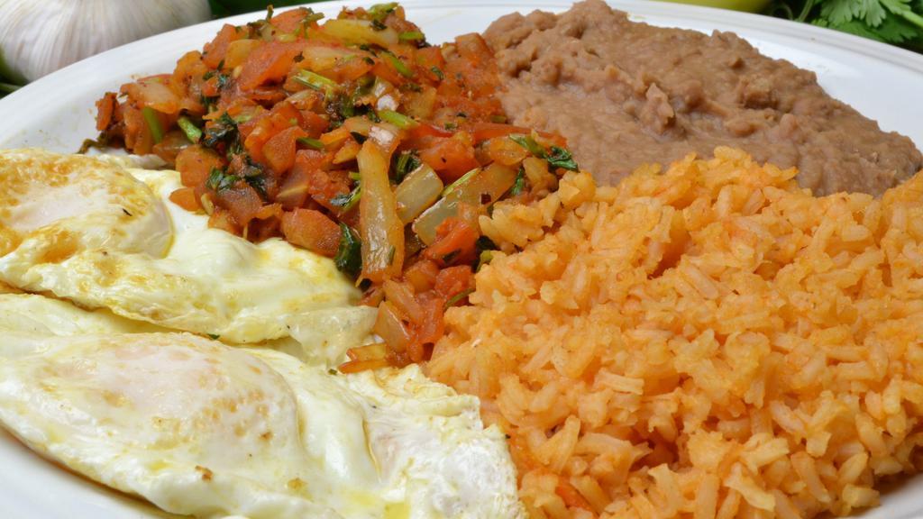 Huevos Rancheros Breakfast Platter · Served with 2 eggs, tortilla, rice, and beans.