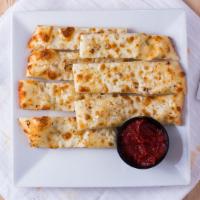 Cheesesticks · Fresh dough brushed with garlic and olive oil. Topped with mozzarella cheese.