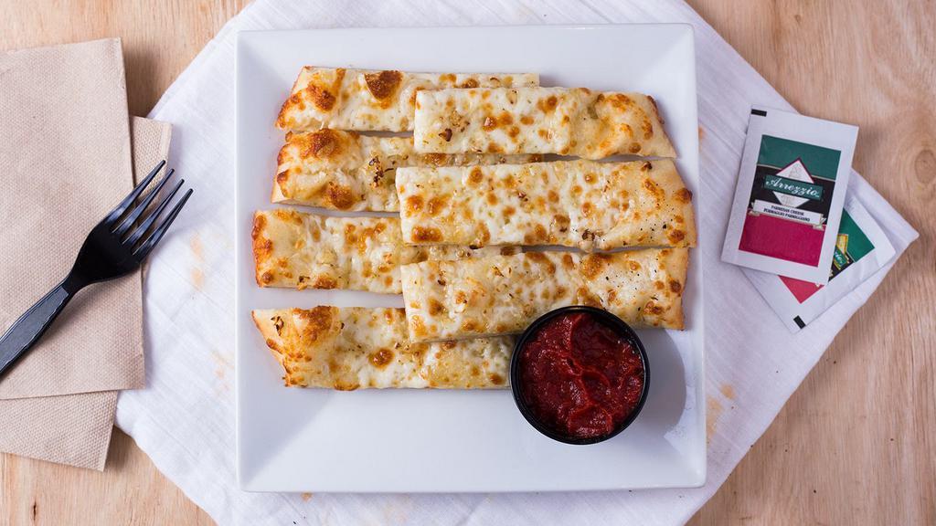 Cheesesticks · Fresh dough brushed with garlic and olive oil. Topped with mozzarella cheese.