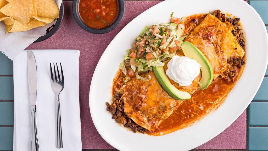 Burrito Al Pastor · Marinated pork, filled with rice, beans and topped with melted cheese and sauce, avocado, sour cream and pico de gallo.