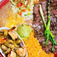 Mar Y Tierra · Carne Asada with shrimp and mushrooms sauteed in butter and garlic, with rice beans, guacamo...