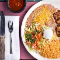 Pollo Asado · Marinated grilled chicken breast, garnished with sour cream, pico de gallo, rice, beans, and...