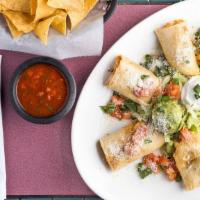 Chicken Taquitos · Flour tortilla filled with chicken and cheese. Served with lettuce, guacamole, sour cream, a...
