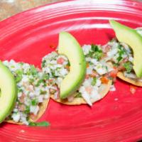 Tostadas De Ceviche (3) · Ground white fish marinated in lime juice, diced tomatoes, avocado, onions, cilantro and jal...