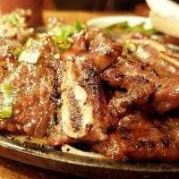 La Galbi · Specially marinated short ribs served over sizzling onion.