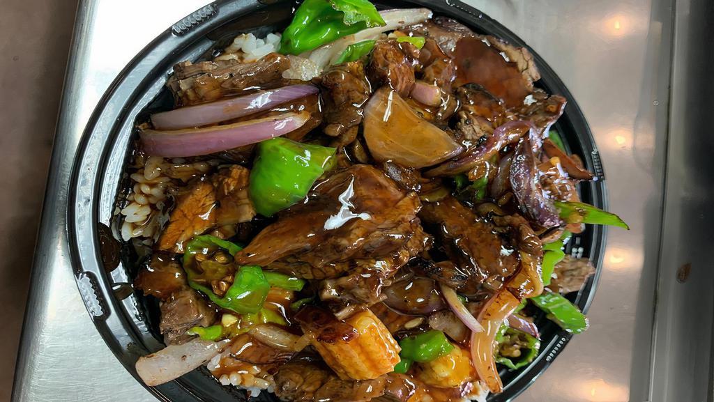 Shishito Bowl · Grilled steak or chicken wok seared with baby corn, shishito peppers and red onions placed on a bed of rice and glazed with spicy honey garlic sauce.