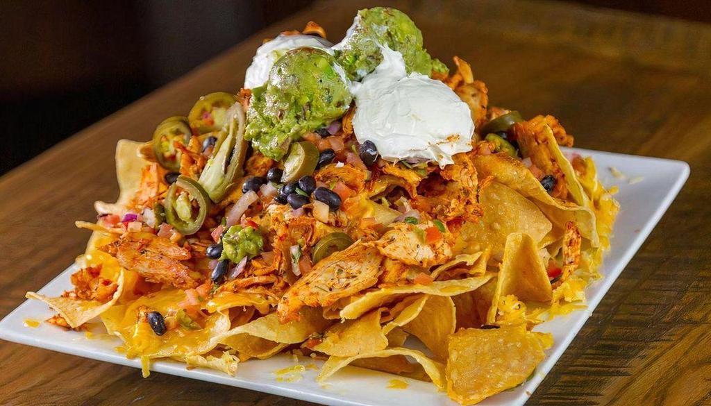 Big Azz Nachos · tortilla chips / black beans /
roasted pepper cheese sauce / pico de gallo / jalapeños / sour cream / guacamole. Add Chicken, Ground Chuck or Chili for an additional price.