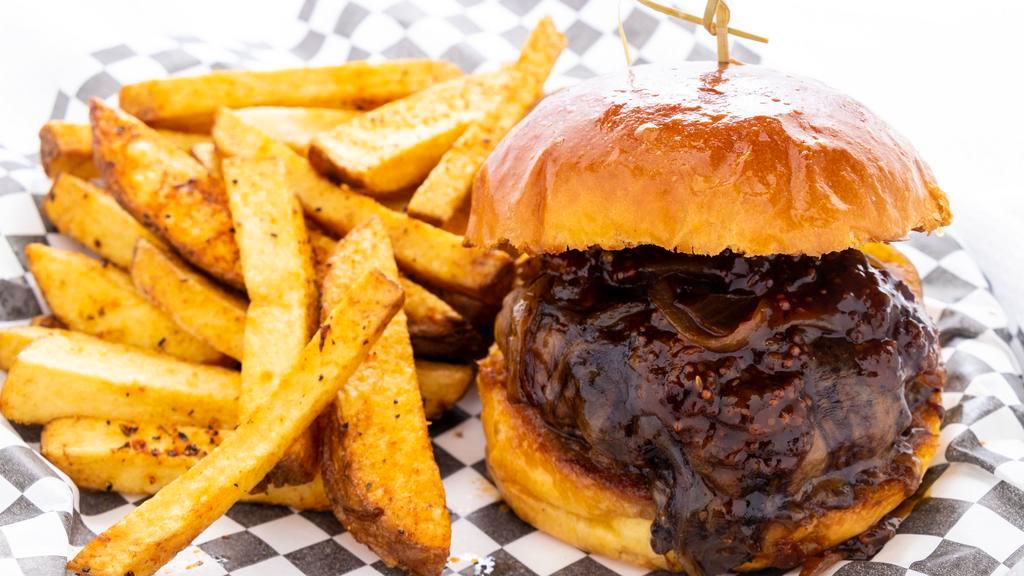 Beer And Bacon Burger · 6 oz. hand-packed fresh beef patty, White Dog Scotch Ale bacon jam (blend of bacon, onions, and beer), white cheddar and porter sauce, on a toasted brioche bun.
