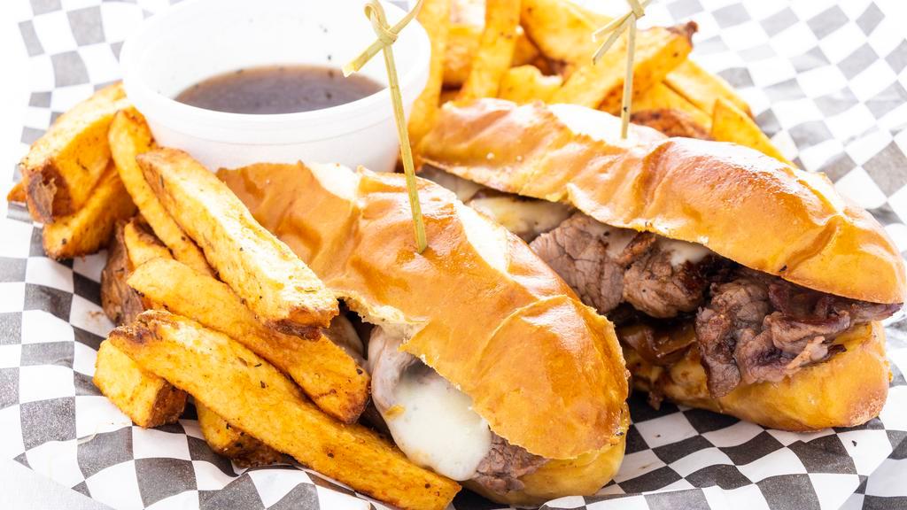 French Dip · Smoked thin sliced strip loin (New York steak), rye aioli, beer-marinated onions, Havarti cheese, served on a toasted pretzel roll with au jus