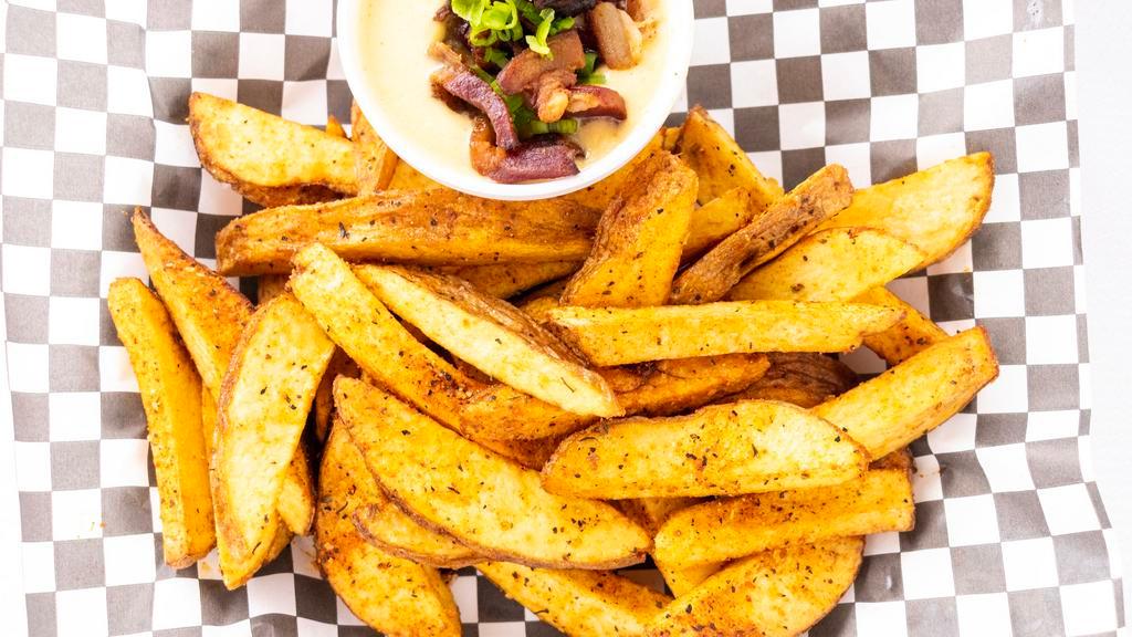 White Dog Fries · Hand-cut fried potatoes, with dry-hopped cheddar sauce (on the side), bacon, and chives.