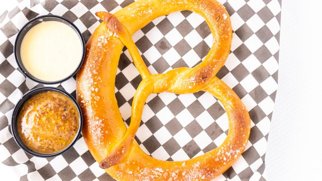 Bavarian Pretzel · Soft pretzel served warm with bourbon mustard and dry-hopped cheddar sauce.
