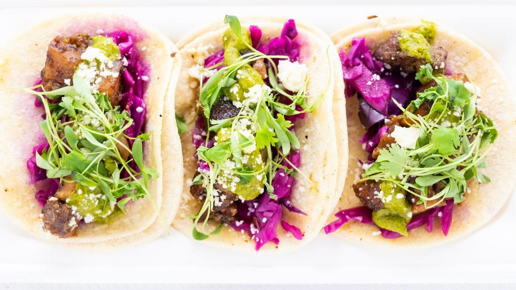 Street Tacos · Three tacos topped with pickled slaw, chimichurri, cotija cheese, and micro cilantro. Choice of pulled pork, shredded beef, or smoked trout.