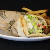 Traditional Gyro · Seasoned beef, tzatziki sauce, feta cheese, cucumber, red onion, lettuce, tomato in a warm G...