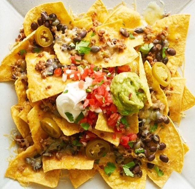 Loaded Nachos · Most loved. Tortilla chips, meat, beans, cheese, pico de gallo, sour cream, and guacamole.