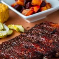 Half Slab · Six St. Louis spareribs dry rubbed and smoked until tender, bread, and a side dish.