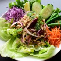 Larb Gai · Ground chicken breast, roasted rice, iceberg lettuce, green beans, cucumber, onions, cilantr...