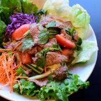 Yum Neau Salad · Sliced beef, lettuce, cucumber, tomato, red onion, cilantro, and with lime vinaigrette dress...