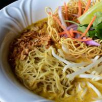 Khao Soi Noodle Soup · Thin egg noodles, bean sprouts, yellow curry, crispy noodles, crispy shallots, lime and cila...