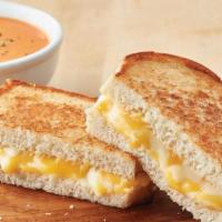 Custom Grilled Cheese + Tomato Soup · Custom cheese blend served on sourdough and paired with our healthier version of a bisque fe...
