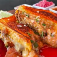 Grilled Cheese · Texas toast, birria, cheese, onions and cilantro.