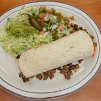 Carne Asada Burrito · A homemade flour tortilla filled with strips of top sirloin, rice and beans, a side of pico ...