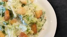 Caesar Salad · Crisp romaine lettuce, shredded Parmesan cheese, Garlic Parmesan croutons and our classic Ca...