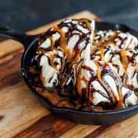 Cookies A' La Mode · Chocolate chip cooke cooked in a skillet, served with vanilla ice cream, chocolate and caram...