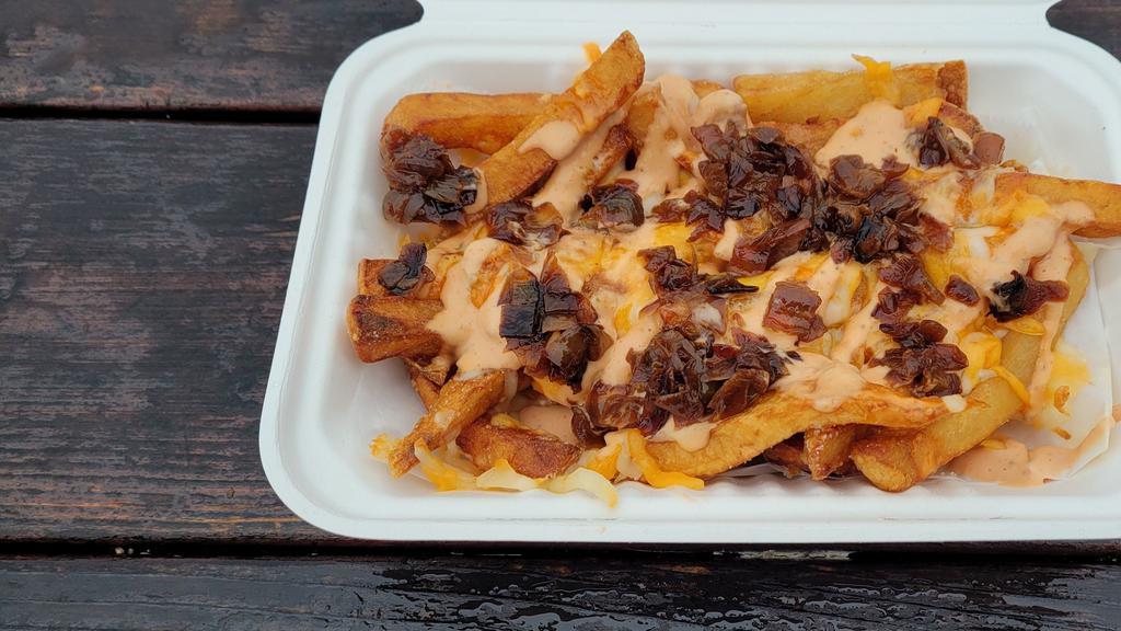 All American Fries · A mound of fries topped with house-made 1000 island, grilled onions, and smothered in a cheddar jack blend!