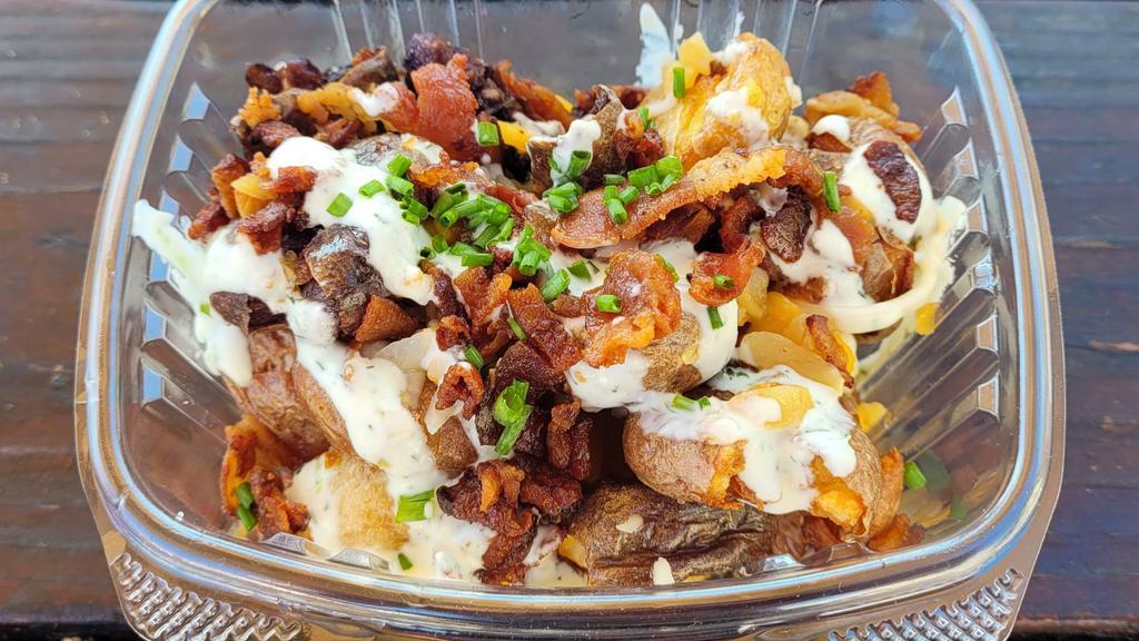 Loaded Smashers · Crispy twice fried baby potatoes with bacon,  ranch, cheddar jack cheese,  and chives