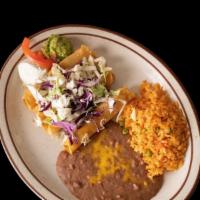 Taquitos Rancheros · 4 crispy corn tortillas, filled with shredded beef or shredded chicken, topped with queso fr...