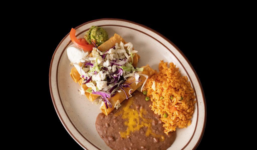 Taquitos Rancheros · 4 crispy corn tortillas, filled with shredded beef or shredded chicken, topped with queso fresco, cabbage and mild sauce,served with sour cream and guacamole.