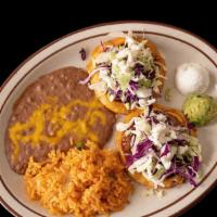 2 Sopes · Homemade thick corn tortilla; topped with beans, shredded beef, shredded chicken or ground b...
