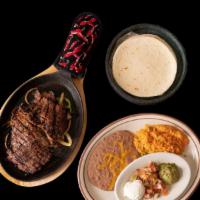 One Meat Fajitas · Choose from steak, grilled chicken, fish or shrimp, served sizzling with bell pepper and oni...