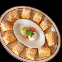 Chicken Taquitos · Rolled crispy flour tortilla stuffed with shredded chicken and cheese, topped with sour crea...