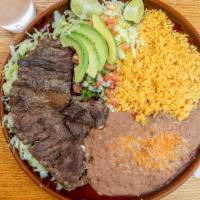 Carne Asada · Juicy beef steak grilled to perfection and served with two sides and corn or flour tortilla.