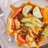 Taco Salad · Tortilla bowl filled with lettuce, diced tomato, pinto beans, avocado, Mexican cheese, and s...